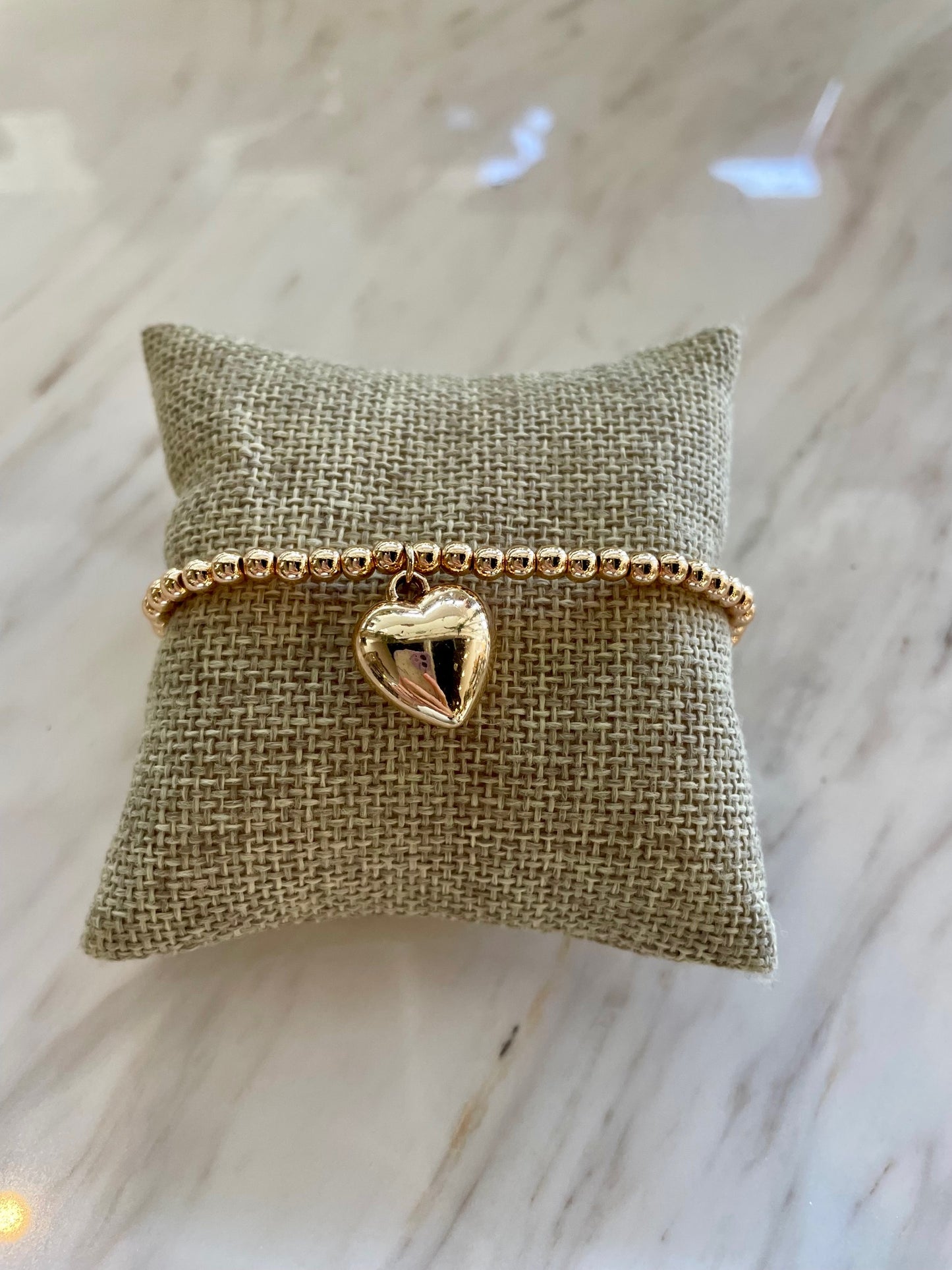 Gold beaded bracelet with heart charm