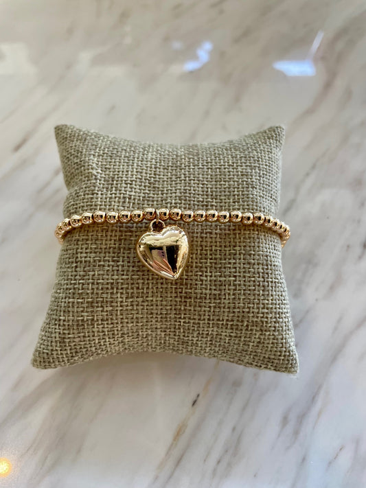 Gold beaded bracelet with heart charm